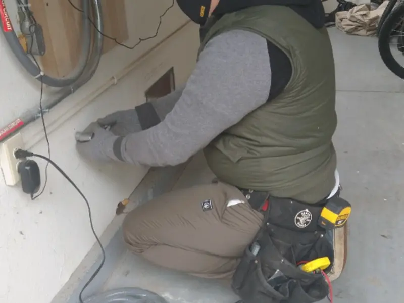 Electrician performing outlet wiring in a Lindale garage